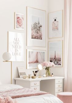 a white bedroom with pictures on the wall