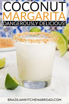 a close up of a drink in a glass with limes on the side and text that reads coconut margarita dangerously delicious