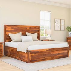 a large bed sitting inside of a bedroom on top of a hard wood floor