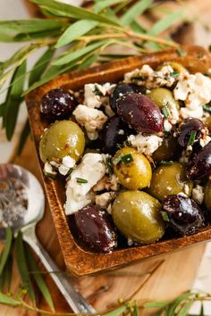 olives and feta salad in a wooden bowl