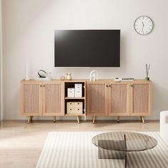 a living room with a large television on the wall and a coffee table in front of it