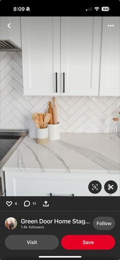 the app is showing an image of a kitchen with white cabinets and marble counter tops