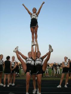 the cheerleaders are doing tricks for the crowd