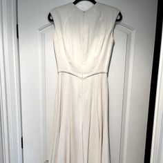 a white dress hanging up on a door