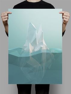 a person holding up a piece of paper with an iceberg in the water on it