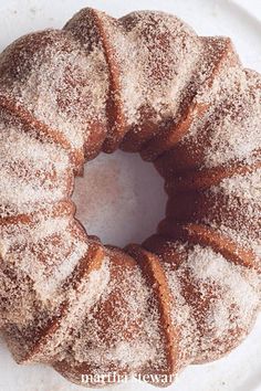 a white plate topped with powdered sugar covered donuts