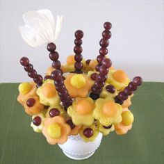 a vase filled with lots of candy and candies on top of a green table