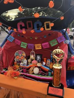 the trunk of a car is decorated with colorful decorations and pictures, including an award