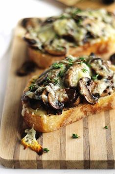 two pieces of bread topped with mushrooms and cheese