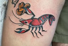 a colorful crab tattoo on the leg with an irish hat and shamrocks around it