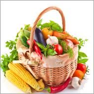 a basket filled with lots of different types of vegetables next to an orange and white sign