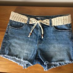 a pair of denim shorts with lace on the side