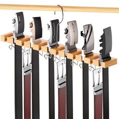 an assortment of knifes hanging on a rack with wooden handles and metal blades attached to them