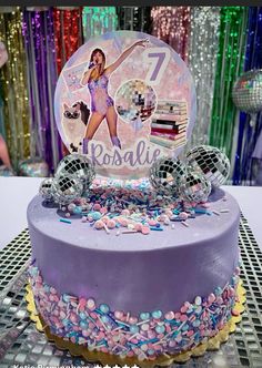 a birthday cake with an image of a woman on top and candy around the edges