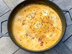 an omelet in a pan on a wooden table