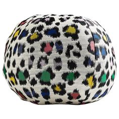 a white and black animal print bag with multicolored spots on the front, sitting against a white background