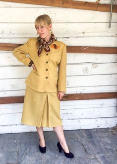 "Lovely 1940's gold woven suit set! The jacket has a slight v neck with brown buttons trailing down the front. The sleeves are long, and the fit is quite straight. The skirt has a front pleat and hits right below the knee.  AS IS: There are moth holes throughout skirt. Please ask for photos if needed.  Measurements include: Jacket Bust: 38\" Jacket Waist: 33\"  Skirt Waist: 28\"  Skirt Hips: 40\"" Classic Skirt Suit For Formal Fall Occasions, Classic Formal Fall Skirt Suit, Classic Fall Semi-formal Skirt Suit, Classic Skirt Suit For Fall Formal Occasions, Classic Fall Formal Skirt Suit, Classic Fall Skirt Suit For Formal Occasions, Gold Notch Lapel Suits For Workwear, Classic Skirt Suit With Buttons For Career, Semi-formal Fitted Suits With Gold Buttons