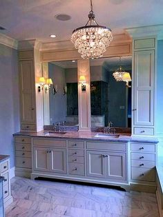 a large bathroom with two sinks and a chandelier