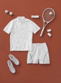 a tennis outfit and shoes are laid out on a red surface next to the racket