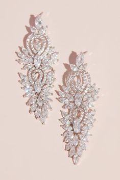 two pairs of earrings on a pink background