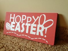 a sign that says hoppy easter on the floor next to a wall with scissors