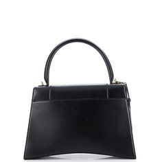 The Balenciaga Hourglass Top Handle Bag is a must-have for any fashion-forward individual. Made from high-quality leather, this new medium size bag is perfect for everyday use and will elevate any outfit. The unique hourglass shape adds a touch of elegance while the top handle allows for easy carrying. Stay stylish and organized with this one-of-a-kind bag. Sleek Satchel With Detachable Strap For Daily Use, Sleek Satchel Shoulder Bag With Detachable Strap, Sleek Top Handle Bag For Everyday, Sleek Shoulder Satchel With Detachable Strap, Sleek Shoulder Bag With Detachable Strap Satchel, Sleek Everyday Bag With Top Handle, Timeless Evening Bag For Everyday Use, Timeless Bags With Detachable Strap, Sleek Bags With Top Handle And Removable Pouch