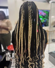 the back of a woman's head with blonde and black dreadlocks