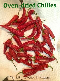 a pile of red chili peppers sitting on top of a white towel with the words oven dried