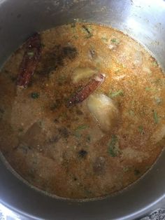 a pot filled with soup sitting on top of a stove