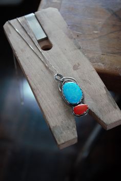 "This color combo is so beautiful! The turquoise is the perfect bright blue to compliment the red coral rosarita. Rosarita is essentially gold infused glass. It's a by product of gold refining. These beautiful stones are set in sterling silver. I wanted a unique way for this pendent to be hung, so I made two organic shaped arches that hold the two jump rings that the sterling silver necklace goes through. The sterling silver vintage chain is around 22\". The pendent is around an 1.5\" long." Red Southwestern Sterling Silver Necklace, Southwestern Blue Cabochon Necklaces, Southwestern Blue Cabochon Necklace, Southwestern Style Blue Cabochon Necklace, Macrame Choker, Gold Disc Necklace, Hemp Necklace, Vintage Chain, Boho Choker