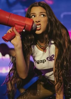 a woman with long hair holding a red megaphone