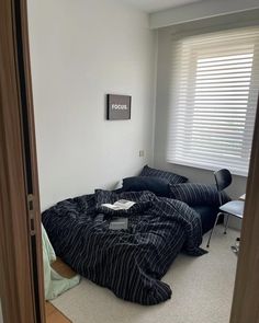 a bedroom with two black beds in it