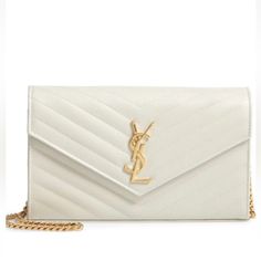 Indulge In Luxury With This Stunning Yves Saint Laurent Envelope Chain Purse. The Cream-Colored Leather Exterior Is Embossed And Quilted In A Chevron Pattern, Beautifully Accented By Gold Hardware And A Gold Chain Strap. This Shoulder Bag Features A Snap Closure And A Rectangle Shape, Perfect For Carrying All Your Essentials. Inside, The Black Lining Adds A Touch Of Sophistication While The Brand Card And Original Box And Dust Bag Provide Authenticity. Ideal For Any Occasion, This Saint Laurent Bag Is A Must-Have For Any Woman's Collection. White Chic Wallet On Chain For Formal Occasions, Chic White Wallet On Chain For Formal Occasions, Classic White Wallet On Chain For Formal Occasions, White Luxury Wallet On Chain For Formal Occasions, Luxury White Wallet On Chain For Formal Occasions, Luxury White Wallet On Chain For Evening, Elegant White Wallet On Chain For Formal Occasions, Formal White Rectangular Wallet On Chain, Elegant White Wallet On Chain For Evening