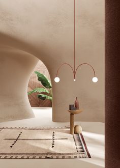 a room with a rug, table and two lights hanging from it's ceiling