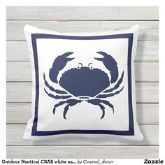 a white and blue crab pillow on a white background with the words, outdoor nautical crab throw