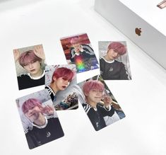 several photos of the same person with pink hair on an apple computer screen and in front of them is a white box