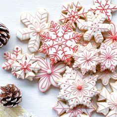 several decorated cookies and pine cones on a table