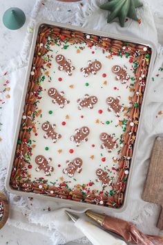 a pan filled with frosted christmas cookies and sprinkles on top of a table