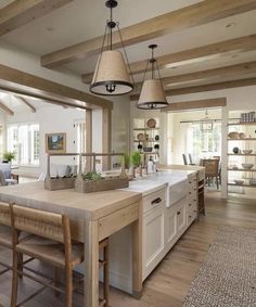 an instagram photo of a kitchen and dining room with wood beams on the ceiling