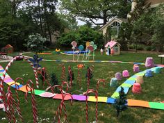 a yard decorated with candy canes and decorations