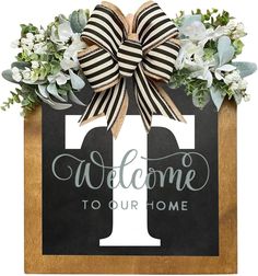 a welcome sign with a bow on it