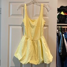 Brand New Without Tags. Size Small But Very Stretchy. Mini Bubble Skirt Dress In Yellow. Can Be Dressed Down With Sandals Or Sneakers And Can Be Dressed Up With Heels. Luxury Activewear, Floral Wrap Maxi Dress, Yellow Tank, Flowy Mini Dress, Golf Dresses, Black Satin Dress, Bubble Skirt, Sleeveless Bodycon Dress, Pleated Mini Dress