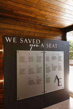 a sign that says we saved from a seat in front of a window with the words on it