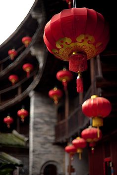 red lanterns hanging from the side of a building