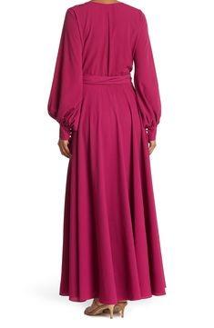 A dramatic wrap maxi dress adds eye-catching style that's perfect for any occasion. 62" length (size Small) Surplice V-neck Long sleeves Attached waist tie Partially lined 100% polyester Hand wash, dry flat Made in the USA Flowy Long Sleeve Wrap Dress, Purple Long Maxi Dress For Fall, Purple Maxi Dress For Fall, Modest V-neck Maxi Dress For Party, Purple V-neck Maxi Dress For Fall, Pink Floor-length Maxi Dress For Fall, Purple Flowy Long Sleeve Maxi Dress, Billowy Sleeves, Classic Slippers