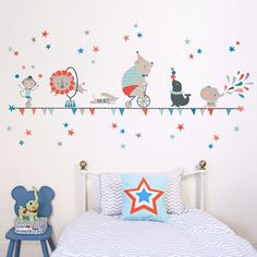 a child's bedroom decorated in blue, red and white with stars on the wall