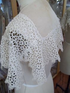 a mannequin with white crochet on it's back and shoulders