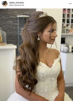 a woman with long hair wearing a wedding dress