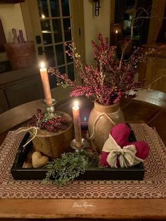 a table with candles, flowers and other items on it