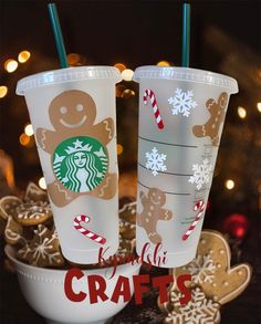 two starbucks cups decorated with gingerbreads and candy canes